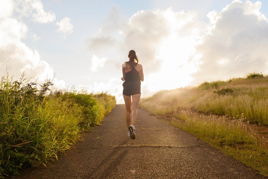 Woman running on narrow path