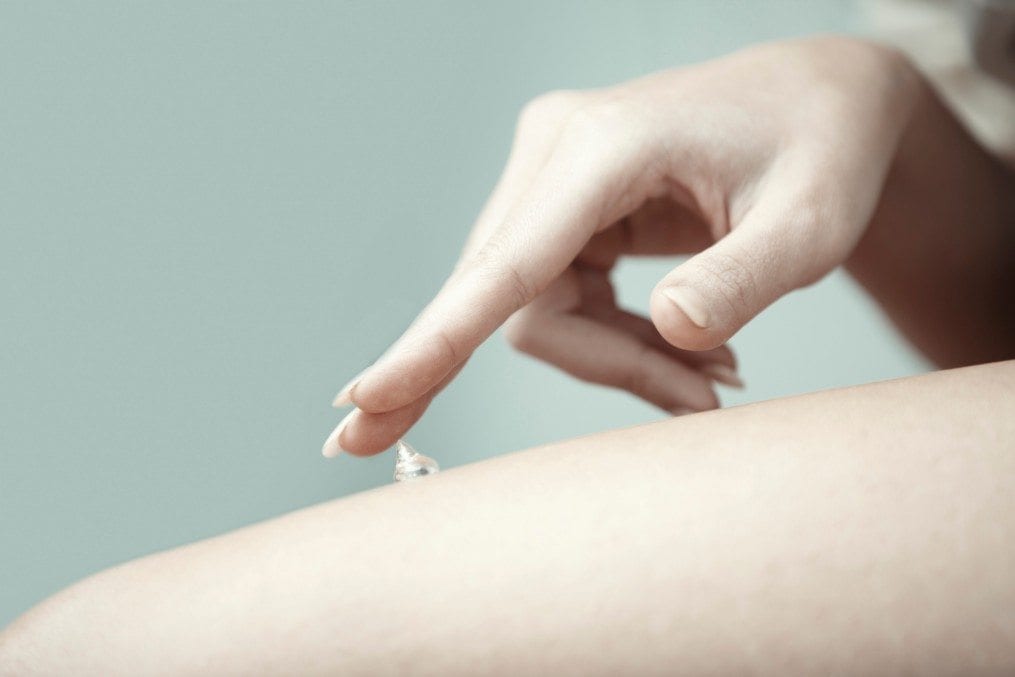 Woman applying beauty cream