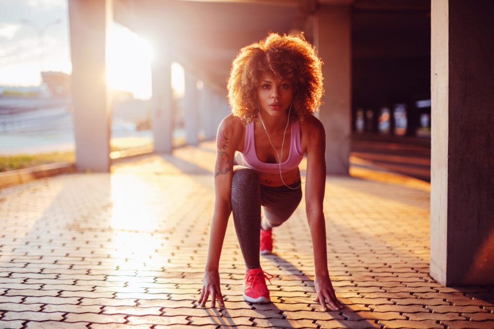 Young woman getting ready to run