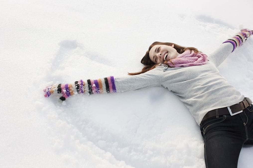 Woman creating a snow angel