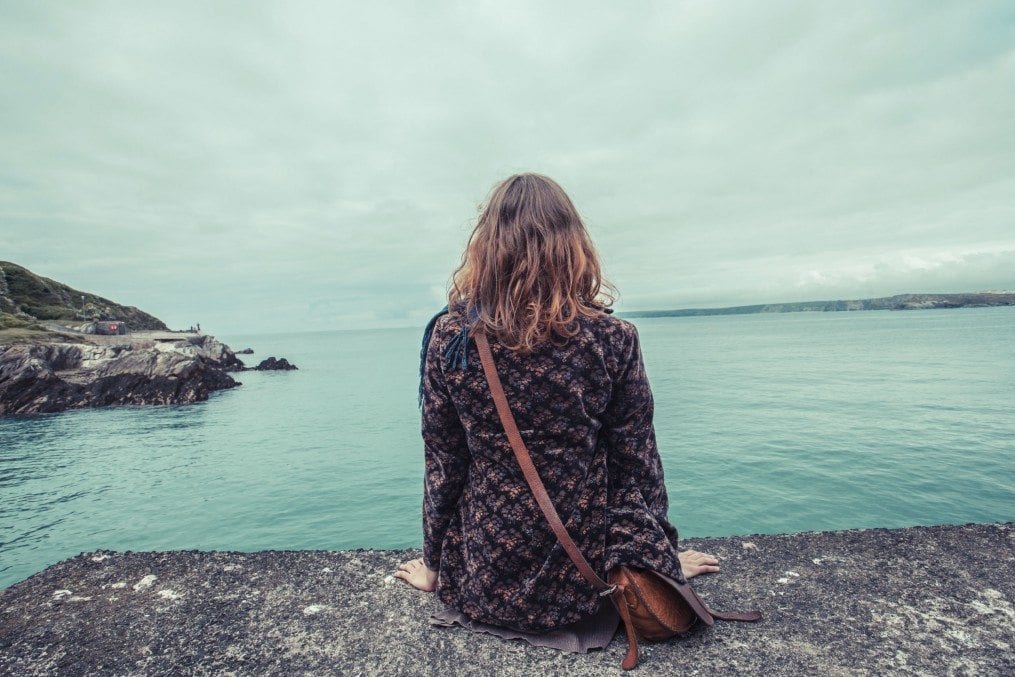 Young woman by the water's edge